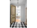 Stunning foyer with black and white checkered tile, a chandelier, and a view into the dining room at 833 Martina Ne Dr, Atlanta, GA 30305
