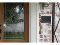 Close-up of a detailed glass front door beside a historical landmark plaque on a vintage brick wall at 833 Martina Ne Dr, Atlanta, GA 30305