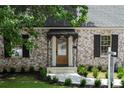 Inviting home entrance featuring a stylish awning, elegant door, and manicured landscaping at 833 Martina Ne Dr, Atlanta, GA 30305
