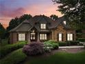 Lovely home exterior featuring manicured landscaping, brick and stone facade, and inviting front porch at 3341 Anna Ruby Ln, Buford, GA 30519