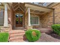Welcoming front porch with brick and stone details, double doors, and beautiful wreaths at 3341 Anna Ruby Ln, Buford, GA 30519