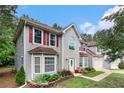Two-story home with red shutters, a two-car garage, and manicured front yard at 4615 Thermal Ct, Douglasville, GA 30135