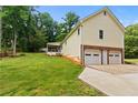 Lawn view showing house, 2 car garage and deck at 670 Dena Dr, Canton, GA 30114