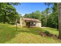 View of house from back lawn with small rear deck at 670 Dena Dr, Canton, GA 30114