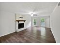 Inviting living room with hardwood floors and a traditional fireplace at 8683 Twin Oaks Dr, Jonesboro, GA 30236