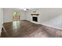Spacious living room featuring hardwood floors and a sliding glass door to the deck at 8683 Twin Oaks Dr, Jonesboro, GA 30236