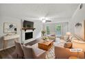 Cozy living room with a brick fireplace, neutral furnishings, and abundant natural light at 8683 Twin Oaks Dr, Jonesboro, GA 30236