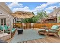 Outdoor deck with comfortable seating, a large umbrella, and a wooden privacy fence at 1294 Parkview Nw Ln, Kennesaw, GA 30152