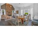Elegant dining room with a round table, hardwood floors, and a stone fireplace at 1294 Parkview Nw Ln, Kennesaw, GA 30152
