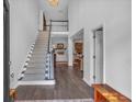 Inviting entryway with hardwood floors, a staircase, and views into the living room at 1294 Parkview Nw Ln, Kennesaw, GA 30152