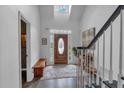 Bright entryway featuring hardwood floors, a wooden bench, and a staircase leading to the upper level at 1294 Parkview Nw Ln, Kennesaw, GA 30152