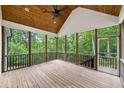 A screened-in porch with wood ceiling, offering an outdoor space to view the surrounding nature at 210 Joe Green Ln, Canton, GA 30114