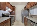 Traditional-style kitchen featuring wood cabinets, stainless steel appliances, and light countertops at 2110 River Green Nw Dr # 2110, Atlanta, GA 30327