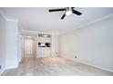 Open living room with hardwood floors, neutral walls, ceiling fan and a view into the kitchen at 2110 River Green Nw Dr # 2110, Atlanta, GA 30327
