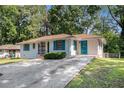 Charming single-story home featuring a well-maintained lawn, updated with vibrant turquoise door and window shutter trim at 2070 Brannen Se Rd, Atlanta, GA 30316