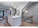Open kitchen with a white island, stainless appliances, wood floors, and modern light fixtures at 2323 Mason Dr # D21, Atlanta, GA 30316