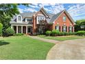 Two-story brick home with well-maintained lawn and a basketball hoop, complemented by charming landscaping and driveway at 3049 Brightwood Se Ln, Marietta, GA 30067