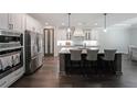 Modern kitchen with stainless steel appliances, large island, and sleek cabinets at 485 Discovery Lake Dr, Fayetteville, GA 30215