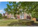 Inviting home with manicured lawn, stone accents, a two-car garage and mature trees, located in a desirable neighborhood at 5415 Fieldfreen Dr, Cumming, GA 30028