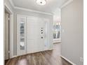 Bright foyer features wood floors, neutral walls and sidelights around the front door at 6806 Glenridge Dr # E, Atlanta, GA 30328