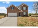 Charming two-story brick home with blue shutters and a two-car garage with a long driveway at 1246 Allspice Way, Lawrenceville, GA 30045