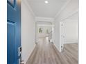 Bright foyer with wood-look flooring and a view through to the backyard and the stairway at 1246 Allspice Way, Lawrenceville, GA 30045