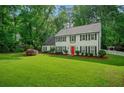 Well-maintained two-story home with a classic design, featuring a vibrant green lawn and mature trees at 1384 Independence Way, Marietta, GA 30062