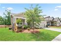 Beautiful home with neutral siding, stone accents, manicured lawn, and sidewalk in a well-maintained community at 169 Hickory Bluffs Pkwy, Canton, GA 30114