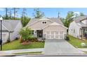 Well maintained single Gathering home with a 2 car garage, stone accents, manicured lawn, and inviting curb appeal at 169 Hickory Bluffs Pkwy, Canton, GA 30114