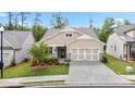 Charming single Gathering home boasts a neutral color palette exterior and landscaped front yard at 169 Hickory Bluffs Pkwy, Canton, GA 30114
