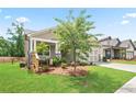 Charming single Gathering home features a covered porch, 2 car garage, and landscaped front yard at 169 Hickory Bluffs Pkwy, Canton, GA 30114