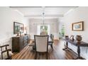 Formal dining room with wood floors, coffered ceilings, and elegant furnishings at 2430 Tack Hill Ct, Dacula, GA 30019