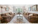 Cozy living room featuring two sofas, a patterned rug, and a bay window at 2430 Tack Hill Ct, Dacula, GA 30019