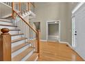 Spacious foyer with hardwood floors, staircase, and bright natural light at 4910 Aldbury Ln, Suwanee, GA 30024