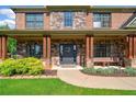 Inviting front porch with stone accents and a cozy seating area at 501 Rabun Ct, Canton, GA 30115