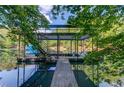A dock with a covered upper deck, providing scenic views of the lake and surrounding trees at 6006 Lanier Heights Cir, Buford, GA 30518