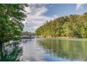 Picturesque lake view showcasing the tranquil waters, lush greenery, and private dock at 6006 Lanier Heights Cir, Buford, GA 30518