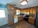 Efficient kitchen with stainless steel appliances and wooden cabinets with laminate floor at 124 Tyler Dr, Mcdonough, GA 30252
