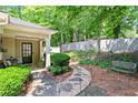 Welcoming front porch with seating and beautifully landscaped garden at 4068 Cottage Oaks Dr, Acworth, GA 30101