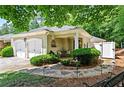 Inviting front yard featuring lush greenery, stone pathway, and cozy seating area at 4068 Cottage Oaks Dr, Acworth, GA 30101