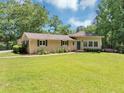 Charming ranch-style home with a well-maintained lawn, mature trees, and covered parking at 4820 Yeager Rd, Douglasville, GA 30135