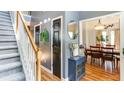 Welcoming foyer with hardwood floors, staircase, and stylish decor leading to a dining room at 118 Valleyside S Dr, Dallas, GA 30157