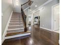 Inviting foyer with hardwood floors, staircase, and an open view to the living spaces at 2227 W Village Se Ln, Smyrna, GA 30080