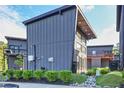 View of gray two-story homes with a modern design, well-maintained landscaping, and ample natural light at 3120 Godby Rd, Atlanta, GA 30349
