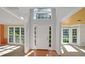 Inviting foyer with wood floors, natural light, white trim, and views into the living and dining room at 1411 Blackland Trl, Lawrenceville, GA 30043