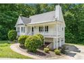 Two-story home featuring a covered porch, side garage and mature landscaping at 1595 Cedar Hl, Douglasville, GA 30134
