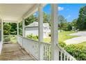 Inviting front porch with views of the surrounding neighborhood and lush greenery at 1595 Cedar Hl, Douglasville, GA 30134