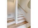 Bright white staircase with wooden handrail and mixed tile flooring adds modern design to the interior at 1968 8Th St, Chamblee, GA 30341