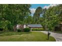 Charming single-story brick home nestled among mature trees with a well-maintained lawn and ample curb appeal at 3250 Valley Bend Rd, South Fulton, GA 30349