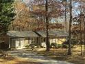 Quaint single-story house with a stone facade, gray roof, and well-maintained landscaping at 3594 Broxton Ln, Snellville, GA 30039